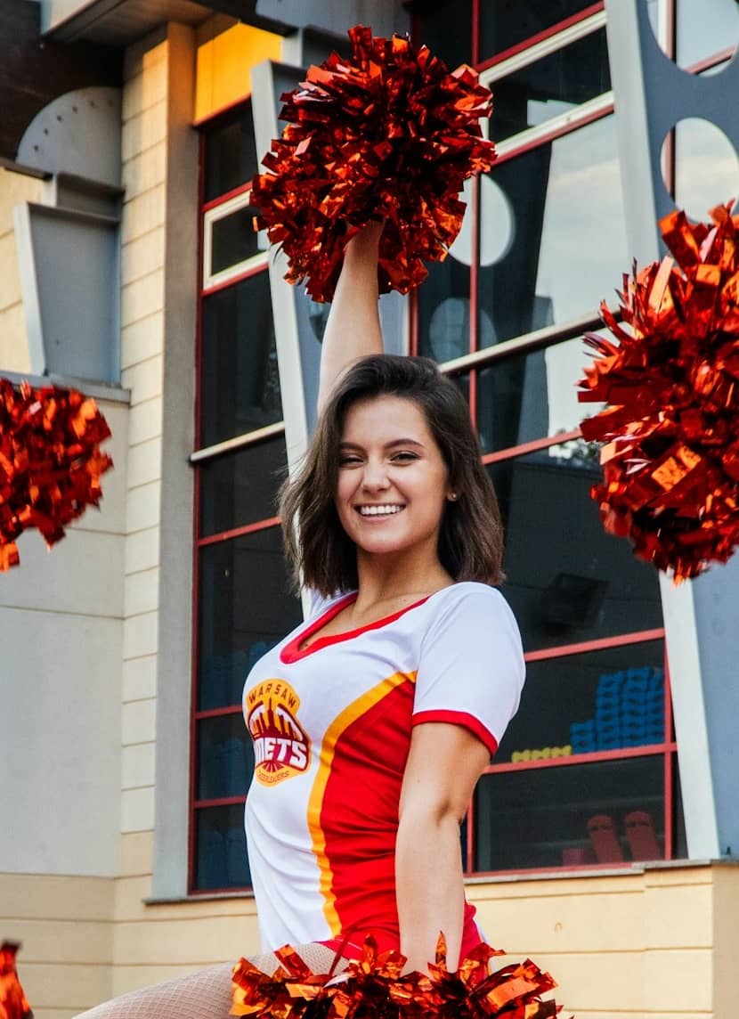 dance team member posing with pom poms