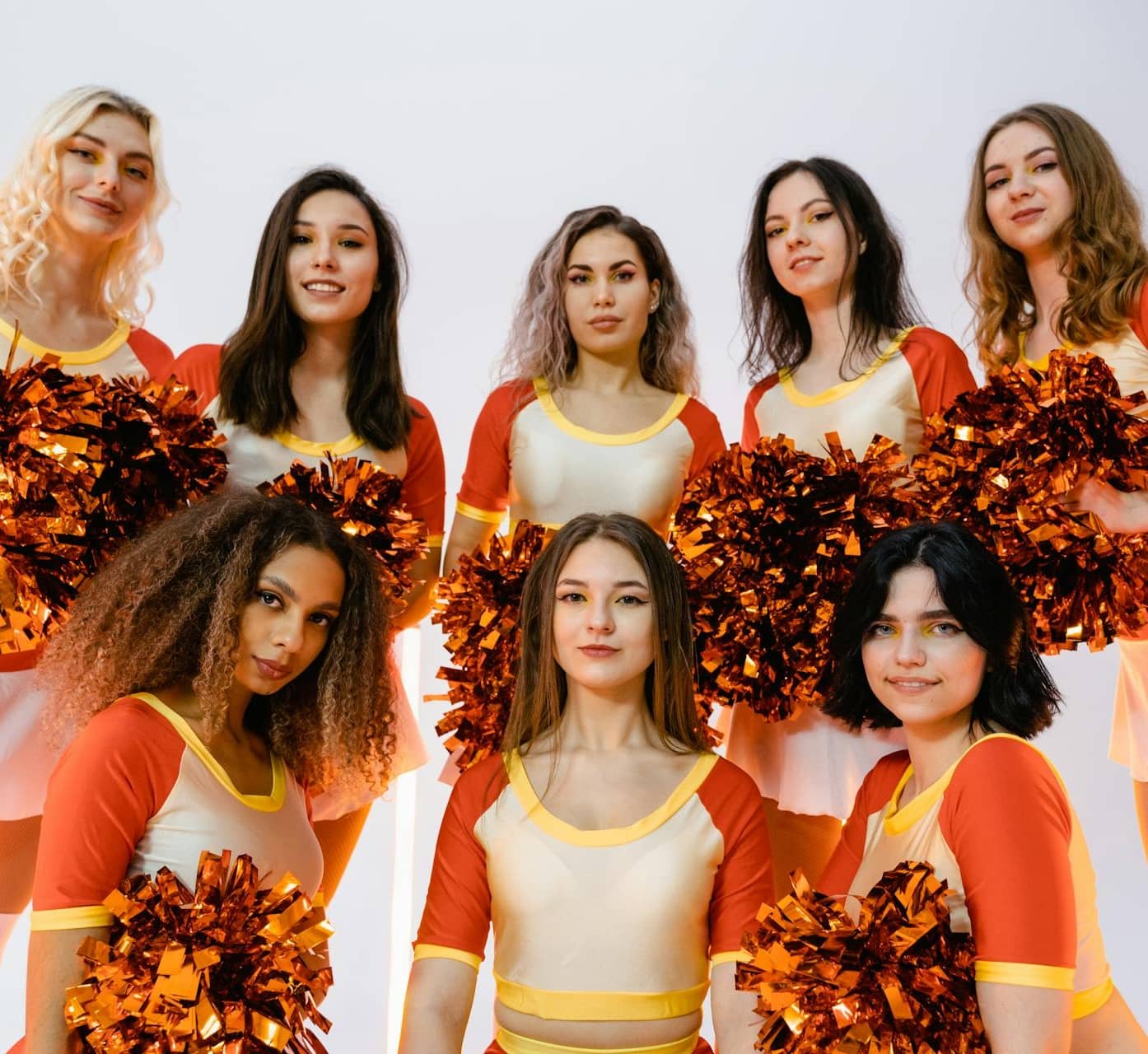 a dance team holding pom poms