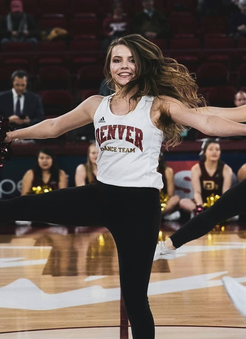 college dance team member performing on basketball court