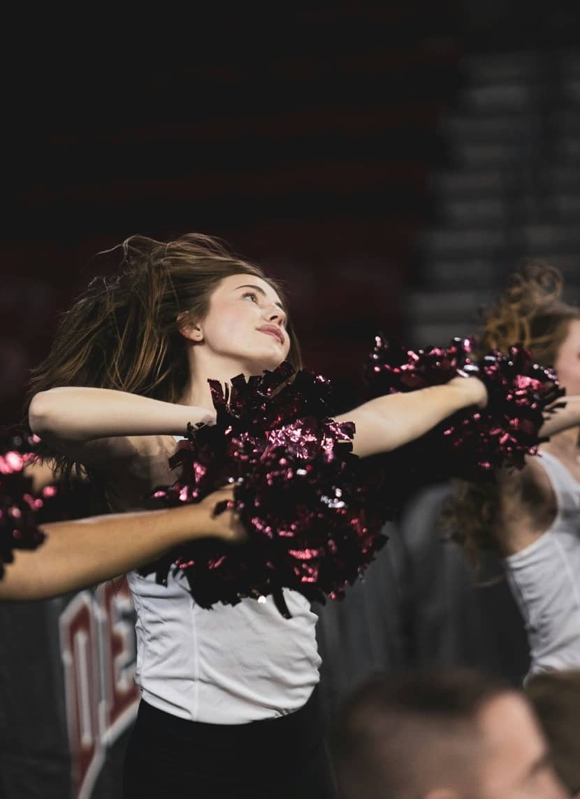 college dance team member performing pom routine